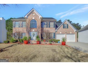 Brick two-story house with a two-car garage and landscaped lawn at 123 Courtneys Ln, Fayetteville, GA 30215