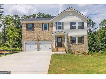 Two-story brick home with a two car garage and landscaped lawn at 760 Great Oak Pl # 22, Villa Rica, GA 30180