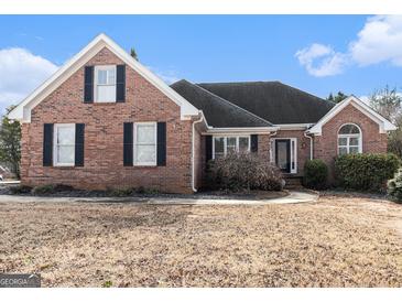 Brick house with a large front yard and mature trees at 600 English Ct, Mcdonough, GA 30252