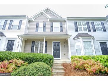 Two-story townhome with gray and white siding, black shutters, and landscaping at 6527 Arbor Gate Sw Dr # Bldg 12, Mableton, GA 30126