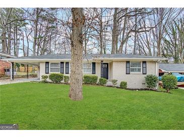 Brick ranch home with a large front yard and mature trees at 2304 Springdale Sw Cir, Atlanta, GA 30315