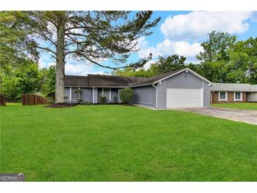 Ranch home with attached garage and spacious lawn at 3205 Cadiz Cir, South Fulton, GA 30349