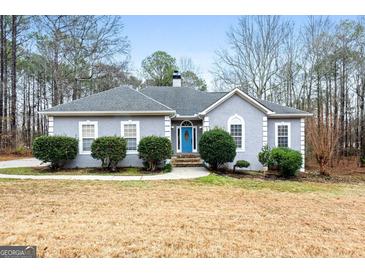 Gray house with blue door, stone steps, and landscaping at 123 Line Creek Way, Sharpsburg, GA 30277