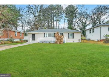 Ranch style home with a spacious lawn and mature trees at 2490 Habersham Dr, Decatur, GA 30032