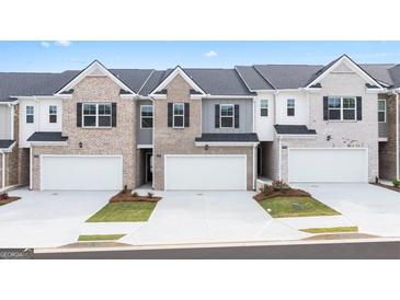 New townhouses with attached garages and landscaping at 315 Silver Moon Drive, Loganville, GA 30052