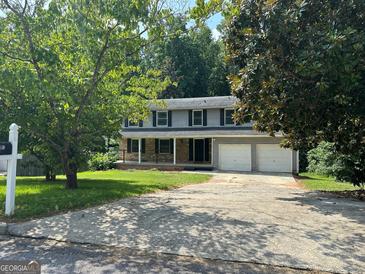 Two-story house with attached garage and landscaped yard at 2691 Old South Dr, Jonesboro, GA 30236