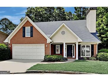 Brick house with a two-car garage and well-manicured lawn at 2673 Northforke Ct, Tucker, GA 30084