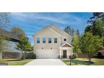 Two-story house with a two-car garage and a well-maintained lawn at 429 Burgundy Se Ter, Atlanta, GA 30354