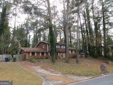 Brick ranch house with a large yard and mature trees. Needs some TLC at 3816 King Henry Sw Rd, Atlanta, GA 30331