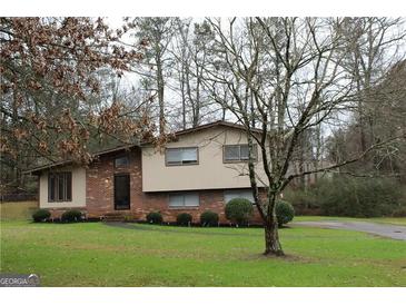 Ranch style home with brick and siding exterior, nicely landscaped lawn at 2405 Falls River Dr, Lithia Springs, GA 30122