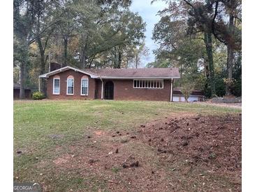 Brick ranch house with a large front yard and mature trees at 793 Pixley Dr, Riverdale, GA 30296
