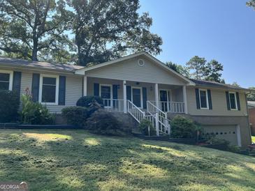 Ranch style home with mature trees and landscaping at 6074 Shallow Wood Ln, Douglasville, GA 30135
