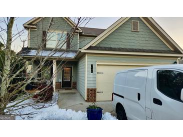 Two-story house with gray siding, a two-car garage, and a small front porch at 2408 Centenary Way Ct, Dacula, GA 30019