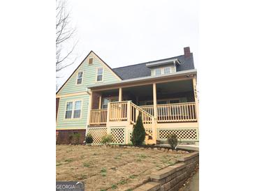 Charming two-story home with front porch and well-maintained landscaping at 1420 Donnelly Ave, Atlanta, GA 30310
