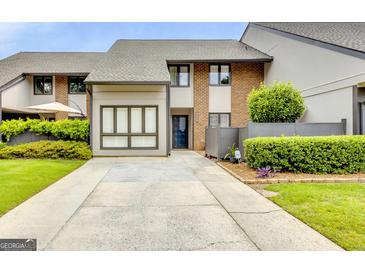 Brick front townhouse with driveway and landscaping at 3252 Clairmont North Ne, Brookhaven, GA 30329