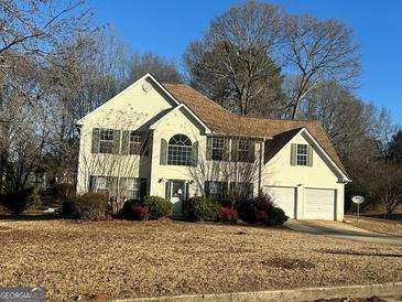 Two-story house with attached garage and landscaping at 4010 Peachtree Farms Rd, Rex, GA 30273