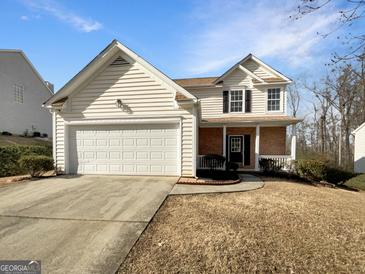 Charming two-story home with a brick facade and a two-car garage at 1535 Valley Club Dr, Lawrenceville, GA 30044
