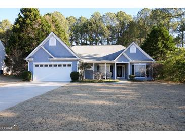 Ranch style home with white garage door and front porch at 756 Stonehaven Chase, Mcdonough, GA 30253