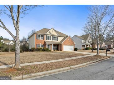 Brick house with two-car garage and landscaped yard at 985 Buckhorn Bnd, Locust Grove, GA 30248