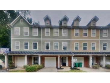 Three-unit townhome building with attached garages and private decks at 1699 Redan West, Lithonia, GA 30058
