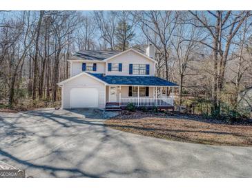 Two-story house with attached garage and porch at 169 Holly Ct, Loganville, GA 30052