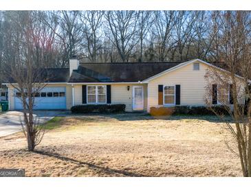 Charming single-story home featuring an attached garage and cozy front yard at 106 Gwenellen Dr, Locust Grove, GA 30248