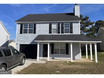 Two-story house with gray siding, a covered porch, and a attached garage at 9418 Sleepy Hollow Ln, Jonesboro, GA 30238