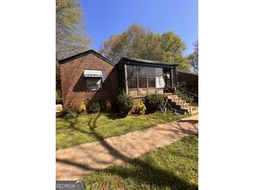 Brick ranch home with sunroom and landscaped yard at 426 E Rhinehill Se Rd, Atlanta, GA 30315
