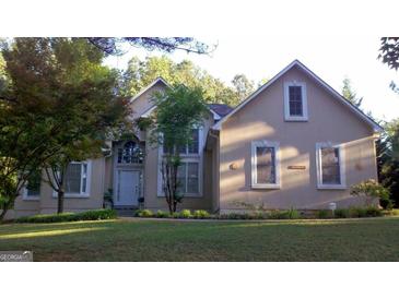 Two-story house with stucco siding, landscaping, and a large front yard at 190 Oakwood Lakes Dr, Hampton, GA 30228