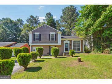 Two-story house with a well-maintained lawn and landscaping at 6291 Laurel Post Dr, Lithonia, GA 30058