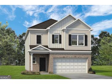 Two-story house with light beige vinyl siding, brown roof, and a two-car garage at 10462 Trellis Lane (Lot 41), Hampton, GA 30228