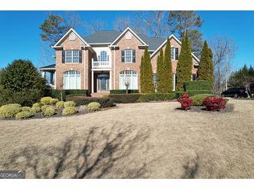 Brick two-story house with landscaped yard and driveway at 7631 Garland Cir # 4, South Fulton, GA 30349