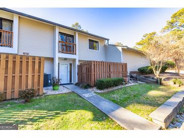 Two-story townhouse with wooden fence and small front yard at 172 Twiggs Cor, Peachtree City, GA 30269
