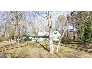 Ranch home with a large front yard and mature trees at 9266 Brave Ct, Jonesboro, GA 30236