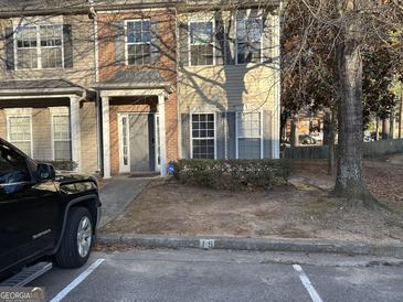 Inviting townhouse featuring a mix of brick and siding with well-maintained landscaping at 20 Sw Pine Canyon Sw Dr, Atlanta, GA 30331