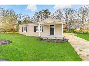 Newly renovated brick ranch home with a covered porch and well-manicured lawn at 1876 Flat Shoals Se Rd, Atlanta, GA 30316