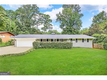 Ranch style home with attached garage and well-manicured lawn at 3721 W Potomac Dr, East Point, GA 30344