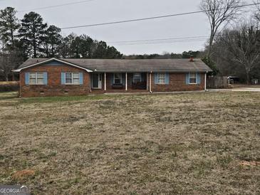Ranch style brick home with a large front yard at 4881 Highway 155 N, Stockbridge, GA 30281