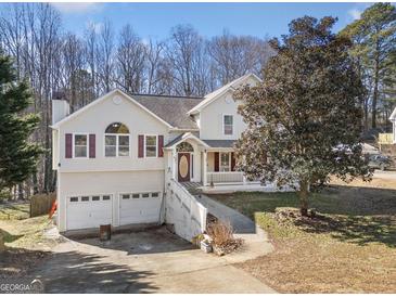 Classic home featuring a two-car garage, front porch, and driveway at 232 Taylors Farm Dr, Canton, GA 30115
