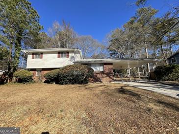 Brick ranch home with carport and mature trees at 730 N Carter Dr, Jonesboro, GA 30236