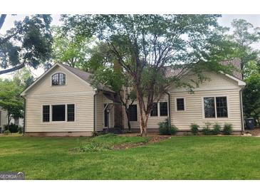 Charming single Gathering home featuring a well-manicured lawn and inviting facade at 213 W Hightower Trl, Social Circle, GA 30025
