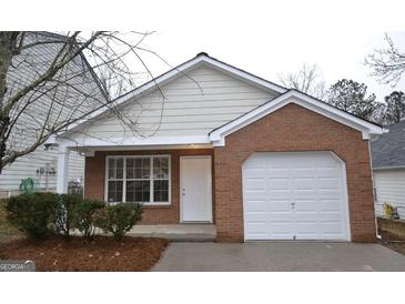 Brick ranch home with a white garage door at 6627 Coventry Pt, Austell, GA 30168