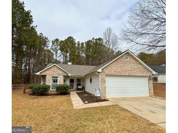 Brick ranch home with attached garage and landscaped yard at 12 Carey Ct, Grantville, GA 30220