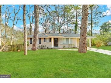 Ranch style home with a spacious lawn and mature trees at 3006 Remington St, East Point, GA 30344
