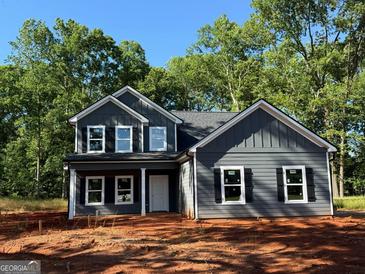 Charming two-story home featuring gray siding, a covered front porch, and black shutters at 148 Asa Moseley Rd, Mcdonough, GA 30252