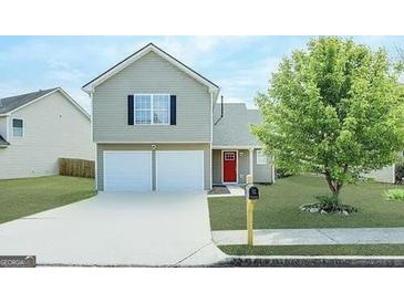 Two-story house with a two-car garage and red door at 270 Marriott Dr, South Fulton, GA 30349