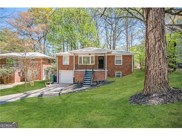 Brick ranch home with a spacious yard and attached garage at 211 Hemphill School Rd, Atlanta, GA 30331