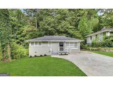 Newly renovated house with a freshly paved driveway and a well-maintained lawn at 1991 Marvin Sw Ln, Atlanta, GA 30311