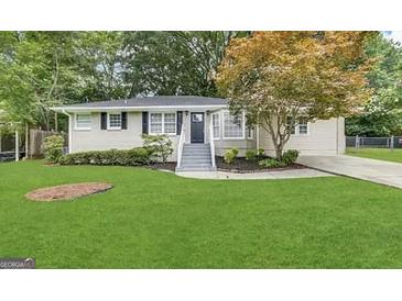 Ranch style home with gray siding, landscaping, and a spacious lawn at 6419 Katherine St, Douglasville, GA 30134