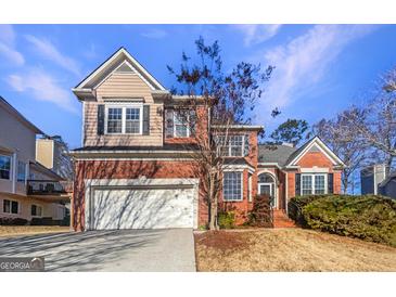 Beautiful two-story home featuring a brick and siding exterior and an attached two-car garage at 3905 Colonial Sw Trl, Lilburn, GA 30047